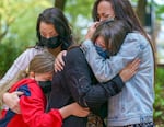 Kennedy Garrett, 24, center, is comforted by her sister, right, and family members after speaking about her father, Robert Delgado of Portland, who was killed by Portland Police in Lents Park earlier in the month.
