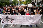 FILE - Young people hold a banner as they lead a celebratory march for Indigenous Peoples Day, Oct. 9, 2023, in Seattle.