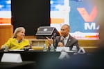 In this photo, House Minority Leader Hakeem Jeffries and Rep. Susan Wild sit next to one another at a table during a roundtable discussion about voting rights at Greater Shiloh Church in Easton, Pa., on Oct. 10. Jeffries is wearing a gray suit and is speaking into a microphone. Wild is wearing a yellow top and is looking in his direction.