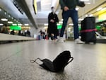 A mask lies on the ground at John F. Kennedy International Airport in New York City on April 19.