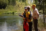 Search and rescue team members discuss their drone flight plan as the prepare to make a pass down Dillon Falls, along the Deschutes River in Deschutes County, Ore., on July 29, 2025. The SAR crew of April Davis, Kent Stevens, Randy Sargent and Mark Tuttle were under strict orders to not speak with journalists.