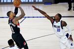 Portland Trail Blazers guard Damian Lillard (0) shoots as Dallas Mavericks forward Dorian Finney-Smith (10) attempts to block during the second half of an NBA basketball game Tuesday, Aug. 11, 2020, in Lake Buena Vista, Fla.