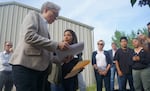 FILE- Gov. Tina Kotek on May 3, 2023 at the home of Ana Maria Rodriguez, a Boardman resident and Oregon Rural Action organizer, whose well water has nearly four times the safe drinking water limit for nitrate. Kotek was visiting with residents in Boardman, who are concerned that progress on the nitrate pollution in the Lower Umatilla Basin has been slow.