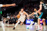 Phoenix Suns guard Devin Booker (1) drives down the court during the first half of an NBA basketball game against the Portland Trail Blazers on Tuesday, Nov. 18, 2025, in Portland, Ore.