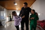 Mohammad Abu Queider spends time with his daughter Maryam (left) and niece Zahara Abu Queider at his home.