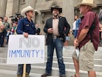 FILE - In this Aug. 24, 2020, file photo Ammon Bundy, center, who led the Malheur National Wildlife Refuge occupation, stands on the Idaho Statehouse steps in Boise, Idaho.