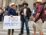 FILE - In this Aug. 24, 2020, file photo Ammon Bundy, center, who led the Malheur National Wildlife Refuge occupation, stands on the Idaho Statehouse steps in Boise, Idaho.