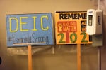 Signs supporting Estacada's Diversity, Equity and Inclusion committee lean against a wall at city hall on Feb. 24, 2025. City officials agreed to dissolve its DEI committee, echoing national rhetoric.