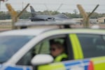 A B1 bomber prepares to take off as police officers man a checkpoint near RAF Fairford air base, in Fairford, England Tuesday, Sept. 29, 2026.