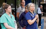 Veterinary staff at Blue Pearl Pet Hospital watch the procession.