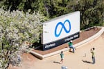 FILE - Visitors take photos at a sign outside Meta headquarters on Thursday, March 26, 2026, in Menlo Park, Calif.