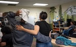 Ramani and Aelina share a moment at the salon. Aelina is a recent graduate of the natural hair care program.