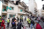 Residents and rescuers gather near a damaged building at the site of an Israeli airstrike in central Beirut's Ras el-Nabaa neighborhood, Lebanon, Sunday, Nov. 17, 2024.