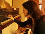 Jennifer Wright uses a shot glass to make music directly on the strings of her Skeleton Piano.