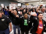 Machinists union members and supporters cheer at a rally asking members to vote against a proposed contract on Jan. 2, 2014, in Seattle.