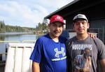 Shane Underwood (left) and his son, David, stand at the Quinault Indian Nation’s seafood plant in Taholah, Washington. The loss of the largest glacier that feeds the Quinault River and rising seas are threatening the tribe’s way of life.