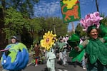 In this photo provided by Making Earth Cool, members Angela McIlvain, Mel Shea and Nora Colie are pictured walking and dancing in an April 2024 Earth Day Celebration.