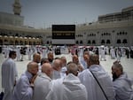A group of Muslim pilgrims discuss the rituals of circumambulating the Kaaba, Islam's holiest site at the Grand Mosque during the annual Hajj pilgrimage in Mecca, Saudi Arabia, Sunday, May 24, 2026. (AP Photo/Altaf Qadri)
