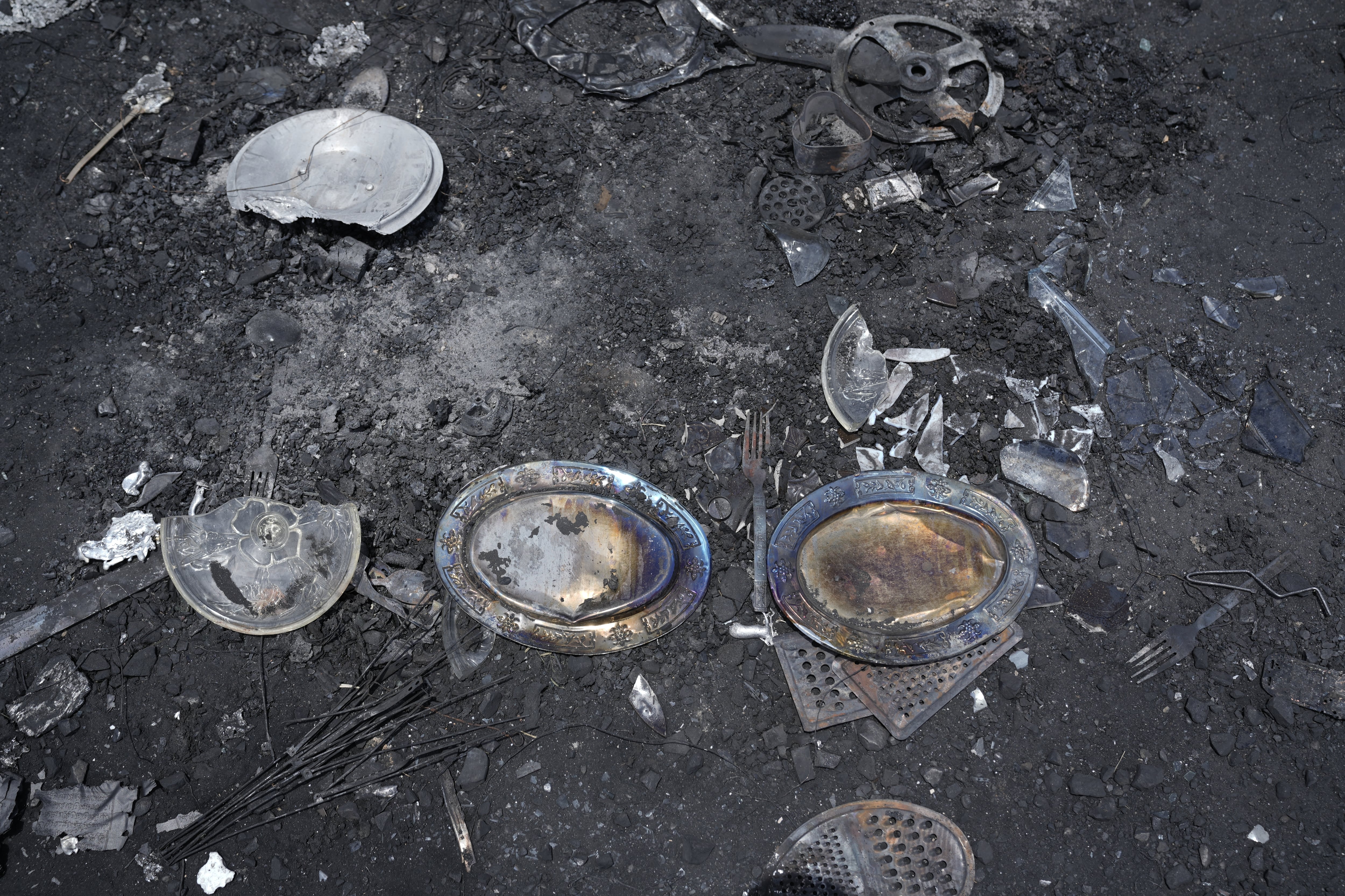 RSF fighters looted tons of goods and tried to take them out of Khartoum toward Western Sudan. But as the Sudanese army advanced, the fighters abandoned much of their loot — like these now burnt plates and cutlery.