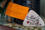 A painted stone and prayer verses at the home of Rebecca and Randy Zuber in Rainier, Ore., on March 13, 2025, on the anniversary of their daughter's death.