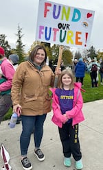 Cara Jamison, left, and her daughter Hailey Moore, 8, attend the Portland Association of Teachers rally held at Roosevelt High School in Portland, Ore., Nov. 1, 2023. “Seeing what the teachers are dealing with in the classroom, in school, how much they’re doing for the students — I know how much it affects my daughter and she values them. I think it’s important to show support,” says Cara Jamison. Hailey attends Sitton Elementary School and adds, “I think it’s really important to help support our teachers and get what we need and get what our teachers need to help us learn.”