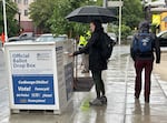 With less than an hour before polls close, voters drop ballots at the box at Multnomah County Elections Division offices, Portland, Ore., May 21, 2024.