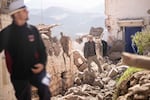 People inspect their damaged homes after an earthquake in Moulay Brahim village, near Marrakech, Morocco.