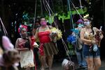 Owners and their pets take part in the annual dog Carnival parade in Rio de Janeiro, Brazil, Saturday, Feb. 13, 2021. Rio's Carnival festivities were canceled due to the new coronavirus pandemic, but pet lovers from around the city gathered for the tradition that drew participants with their furry, four-legged companions to compete for best costume.