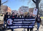 FILE: Demonstrators for the Graduate Teaching Fellows Federation march on the campus of the University of Oregon. The union may go on strike on Jan 17.