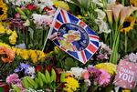 Flowers and pictures of the late Queen Elizabeth II are placed outside of the Palace of Holyroodhouse in Edinburgh.