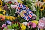 Flowers and pictures of the late Queen Elizabeth II are placed outside of the Palace of Holyroodhouse in Edinburgh.