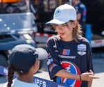 Amira Tawadros, 7, left, discusses what her favorite car in the paddock is with Parker Kincaid, 12. Kincaid has been working on cars since he was two, and this is his second year working in the Meyer Shank Racing pits.