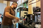 Steven Ramos makes filtered coffee using bottled water on Wednesday April 24. Ramos runs a small coffee shop in Bogotá, but he cannot use his espresso machine when water is cut off in his neighborhood.