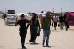 Palestinians carry food and humanitarian aid delivered by the U.S.-backed Gaza Humanitarian Foundation, after receiving the supplies in Rafah, as they arrive in Khan Younis, southern Gaza Strip, on Wednesday, May 28, 2025.