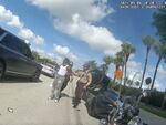 This screenshot from Miami-Dade Police bodycam shows officers after Dolphins player Tyreek Hill had been handcuffed after a traffic stop on Sunday. Hill is talking to a teammate who has just driven by and witnessed what happened.