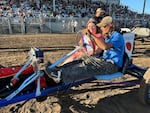 Ben Salo, third-generation Pig-N-Ford racer, takes the Tillamook County Fair's Dairy Princess on a victory lap after his championship win in 2023.