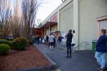 Shoppers stand in line outside Whole Foods in Portland, Ore., on Thursday, March 19, 2020. Grocery stores around the region have implemented social distancing guidelines during the new coronavirus pandemic, such as making customers stand 6 feet apart and limiting the number of people inside.
