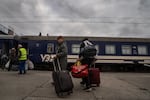 Evacuees from the city of Pokrovsk arrive at the train station in Pavlohrad, Ukraine, on Oct. 15. They are fleeing to cities in western Ukraine or other points in Europe. Pokrovsk, a coal mining center in eastern Ukraine, is under frequent Russian artillery barrages and aerial attacks.