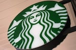A circle shaped sign of the recognizable Starbucks Coffee siren.