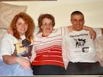 In this undated photo, Erik Banks (right) poses for a photo with his sister Jen McGill, left, and their grandmother. Banks is wearing a T-shirt from a white supremacist band, Skrewdriver.