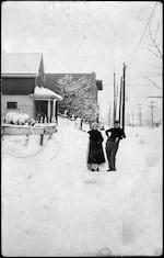 Dewayne Deveny and sister near NE 80th and Glisan over snow storm, Portland, Ore., 1918.
The house on the left was built in 1902 and still stands to this day. The building on the corner just past the house was the home to a grocers when it was first built in 1911 and now is the home to East Glisan, a pizza lounge.