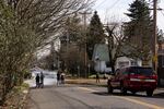 People stand next to flood waters in the Alberta neighborhood of Portland, Ore., Saturday, March 16, 2019. A water main break caused millions of gallons of water to rush the streets of the Northeast Portland neighborhood.