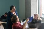 Jennifer Antick (standing) chats with graduate students in one of her psychology classes using a "flipped classroom" model on Wednesday, March 1, 2023, in Hillsboro, Ore.