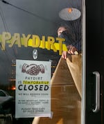 Ezra Caraeff, one of the owners of Paydirt, a bar in Northeast Portland, papers the windows of the bar on Wednesday, Nov. 18, 2020. The bar will close for at least the next four weeks, part of Oregon's "freeze" and effort to slow the spread of COVID-19. 