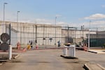 FiLE - A GEO Group guard looks on from behind the fence at the Northwest U.S. Immigration and Customs Enforcement Processing Center, Aug. 13, 2025, in Tacoma, Wash.