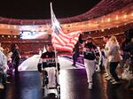Ellie Marks and Paul Schulte hold Team USA's flag during the closing ceremony of the Summer Paralympic Games at Stade de France on Sunday.