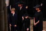 (From L) Britain's Prince George of Wales, Britain's Catherine, Princess of Wales, Britain's Princess Charlotte of Wales and Meghan, Duchess of Sussex attend the state funeral and burial of Britain's Queen Elizabeth, at Westminster Abbey in London on Monday.