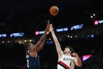 Los Angeles Clippers forward Kawhi Leonard, left, shoots over Portland Trail Blazers forward Deni Avdija (8) during the second half of an NBA basketball game Friday, April 10, 2026, in Portland, Ore.