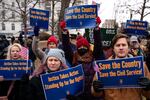 People hold signs during a "Save the Civil Service" rally outside the U.S. Capitol on Feb. 11.