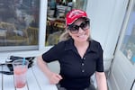 Krista Wagner is sipping a frozen wine, watching a University of Georgia football game in Alpharetta, Ga. on Sept. 17. Wagner voted for Trump in 2016 and then Biden in 2020 but her flip to the Democrats that year wasn't permanent.